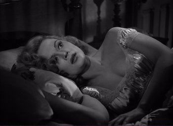 Movie still from “White Heat” (1949), directed by Raoul Walsh – A black and white photo of a woman laying on a bed; Close Up shot, High angle