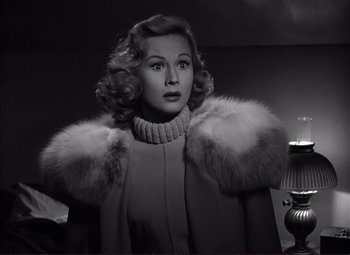 Movie still from “White Heat” (1949), directed by Raoul Walsh – A black and white photo of a woman wearing a fur coat; Close Up shot, Low angle