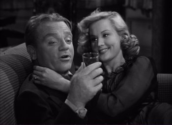 Movie still from “White Heat” (1949), directed by Raoul Walsh – An older man and a younger woman holding a wine glass; Close Up shot, High angle