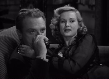 Movie still from “White Heat” (1949), directed by Raoul Walsh – A man and a woman are posing for a picture; Close Up shot, High angle