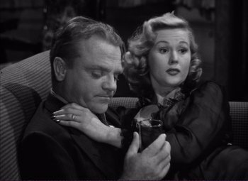 Movie still from “White Heat” (1949), directed by Raoul Walsh – A man and a woman sitting next to each other on a couch; Close Up shot, High angle