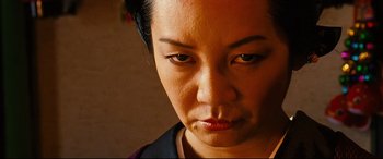 Movie still from “Why Don't You Play in Hell?” (2013), directed by Sion Sono – A person looking at the camera; Close Up shot, High angle