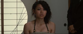 Movie still from “Why Don't You Play in Hell?” (2013), directed by Sion Sono – A woman with a rope around her neck and shoulders; Close Up shot, Low angle