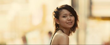 Movie still from “Why Don't You Play in Hell?” (2013), directed by Sion Sono – A young woman with short brown hair posing for a picture; Close Up shot, Low angle