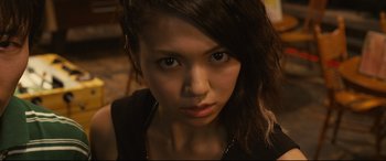 Movie still from “Why Don't You Play in Hell?” (2013), directed by Sion Sono – A person with long brown hair; Close Up shot, Low angle