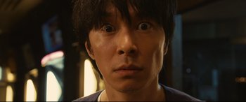 Movie still from “Why Don't You Play in Hell?” (2013), directed by Sion Sono – A person with black hair; Extreme Close Up shot, Low angle