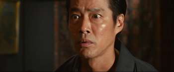 Movie still from “Why Don't You Play in Hell?” (2013), directed by Sion Sono – A man's face looking at the camera; Close Up shot, Low angle