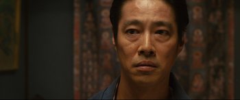 Movie still from “Why Don't You Play in Hell?” (2013), directed by Sion Sono – A man's face in front of a wall; Close Up shot, Low angle