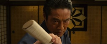 Movie still from “Why Don't You Play in Hell?” (2013), directed by Sion Sono – A man holding a baseball bat in his hand; Close Up shot, Low angle