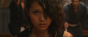 Movie still from “Why Don't You Play in Hell?” (2013), directed by Sion Sono – A young woman's face with blood all over it; Close Up shot, Low angle