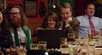 Movie still from “Why Him?” (2016), directed by John Hamburg – A man and a woman sitting at a dinner table looking at a computer; Medium shot, Over the shoulder angle