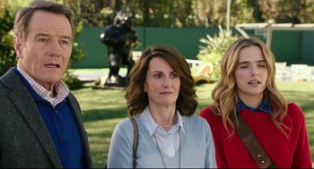 Movie still from “Why Him?” (2016), directed by John Hamburg – A woman standing next to two other women in front of a bear statue; Medium shot, Over the shoulder angle