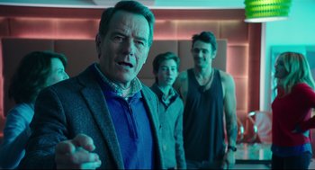 Movie still from “Why Him?” (2016), directed by John Hamburg – A man standing next to two other men in front of a brick wall; Medium shot, Over the shoulder angle