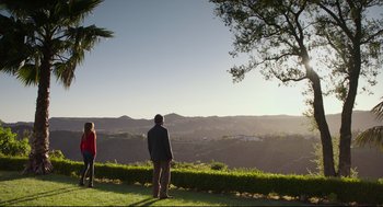 Movie still from “Why Him?” (2016), directed by John Hamburg – A man and a woman standing on a hill overlooking a valley; Extreme Wide shot, Low angle