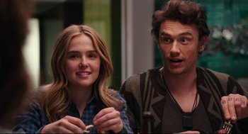 Movie still from “Why Him?” (2016), directed by John Hamburg – A man and a woman sitting next to each other at a table; Close Up shot, Over the shoulder angle