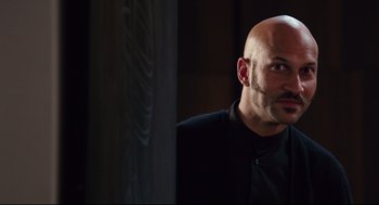 Movie still from “Why Him?” (2016), directed by John Hamburg – A man with bald head looking into the distance; Close Up shot, Over the shoulder angle