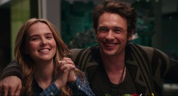 Movie still from “Why Him?” (2016), directed by John Hamburg – A man and a woman smiling for the camera; Close Up shot, Over the shoulder angle