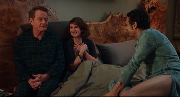Movie still from “Why Him?” (2016), directed by John Hamburg – Two men and a woman sitting on a couch; Medium shot, Over the shoulder angle