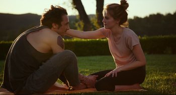Movie still from “Why Him?” (2016), directed by John Hamburg – A man and a woman sitting on the grass; Medium shot, Over the shoulder angle