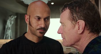 Movie still from “Why Him?” (2016), directed by John Hamburg – A man with a bald head talking to another man; Close Up shot, Over the shoulder angle