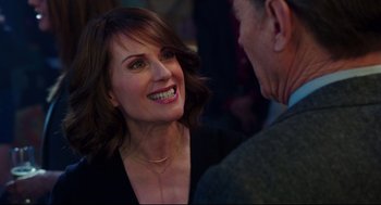 Movie still from “Why Him?” (2016), directed by John Hamburg – A woman smiling at a man in a suit and tie; Close Up shot, Over the shoulder angle