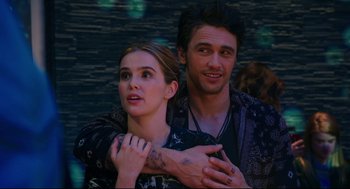 Movie still from “Why Him?” (2016), directed by John Hamburg – A man and a woman standing next to each other; Medium shot, Over the shoulder angle