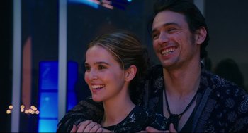 Movie still from “Why Him?” (2016), directed by John Hamburg – A man and a woman smiling for the camera; Close Up shot, Over the shoulder angle