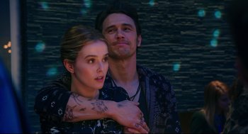 Movie still from “Why Him?” (2016), directed by John Hamburg – A man and a woman standing next to each other; Medium shot, Over the shoulder angle