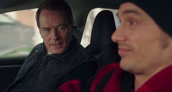 Movie still from “Why Him?” (2016), directed by John Hamburg – Two men sitting in the back seat of a car; Close Up shot, Over the shoulder angle
