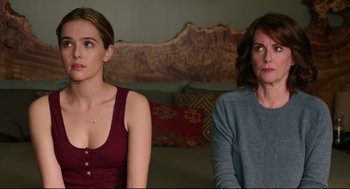 Movie still from “Why Him?” (2016), directed by John Hamburg – Two women sitting next to each other in front of a couch; Medium shot, Over the shoulder angle