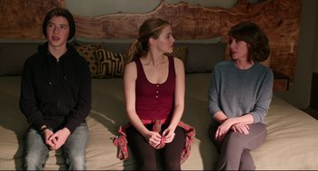 Movie still from “Why Him?” (2016), directed by John Hamburg – A group of people sitting on top of a bed; Medium shot, Over the shoulder angle