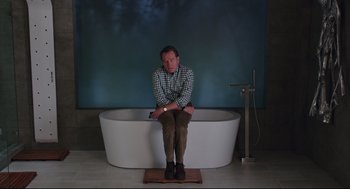 Movie still from “Why Him?” (2016), directed by John Hamburg – A man sitting on the edge of a bath tub; Wide shot, High angle