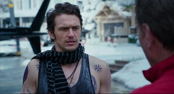 Movie still from “Why Him?” (2016), directed by John Hamburg – A person with a tattoo on their chest; Close Up shot, Over the shoulder angle