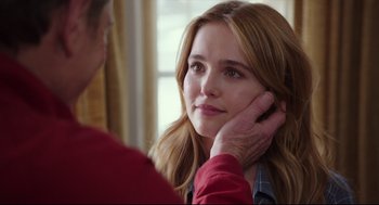 Movie still from “Why Him?” (2016), directed by John Hamburg – A young woman looking at a man with his hand on her ear; Close Up shot, Over the shoulder angle