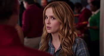 Movie still from “Why Him?” (2016), directed by John Hamburg – A beautiful young lady sitting at a table in a restaurant; Close Up shot, Over the shoulder angle