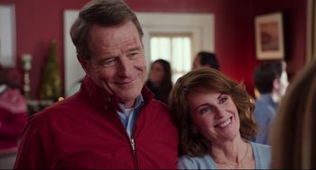 Movie still from “Why Him?” (2016), directed by John Hamburg – A man and a woman smile for a picture; Close Up shot, Over the shoulder angle