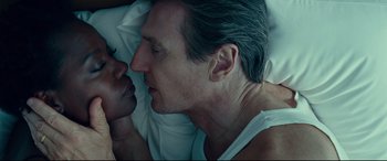 Movie still from “Widows” (2018), directed by Steve McQueen – A person laying in a bed with another person; Close Up shot, Overhead angle