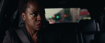 Movie still from “Widows” (2018), directed by Steve McQueen – A woman sitting in the back seat of a car; Close Up shot, Over the shoulder angle
