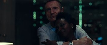 Movie still from “Widows” (2018), directed by Steve McQueen – A man and a woman hugging each other in the dark; Close Up shot, Over the shoulder angle