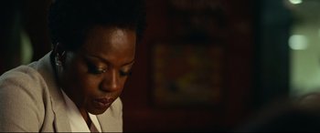 Movie still from “Widows” (2018), directed by Steve McQueen – A person looking down at something; Close Up shot, Over the shoulder angle
