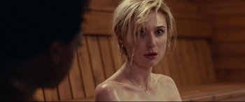 Movie still from “Widows” (2018), directed by Steve McQueen – A beautiful woman with blonde hair and a bare chest; Close Up shot, Over the shoulder angle