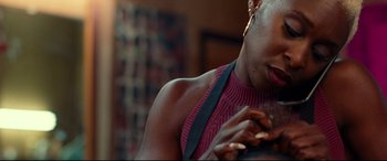 Movie still from “Widows” (2018), directed by Steve McQueen – A person eating a piece of food; Close Up shot, Over the shoulder angle