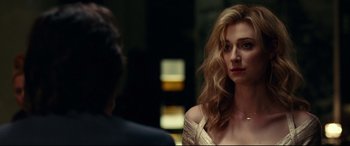 Movie still from “Widows” (2018), directed by Steve McQueen – A woman in a white dress looking at a man in a black suit; Close Up shot, Over the shoulder angle