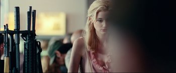 Movie still from “Widows” (2018), directed by Steve McQueen – A woman with blonde hair and a ruffle around her neck; Close Up shot, Over the shoulder angle