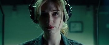 Movie still from “Widows” (2018), directed by Steve McQueen – A person wearing headphones; Close Up shot, Low angle