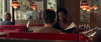 Movie still from “Widows” (2018), directed by Steve McQueen – Two people sitting at a table in front of each other; Medium shot, Over the shoulder angle