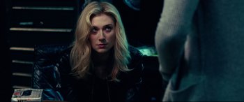 Movie still from “Widows” (2018), directed by Steve McQueen – A woman with long blonde hair stares into the camera; Close Up shot, Over the shoulder angle