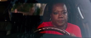 Movie still from “Widows” (2018), directed by Steve McQueen – A woman sitting in the driver's seat of a car; Close Up shot, High angle