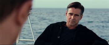 Movie still from “Widows” (2018), directed by Steve McQueen – A person sitting on a boat near the ocean; Close Up shot, Over the shoulder angle