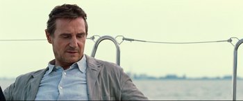 Movie still from “Widows” (2018), directed by Steve McQueen – A person sitting on a boat in the water; Close Up shot, Low angle